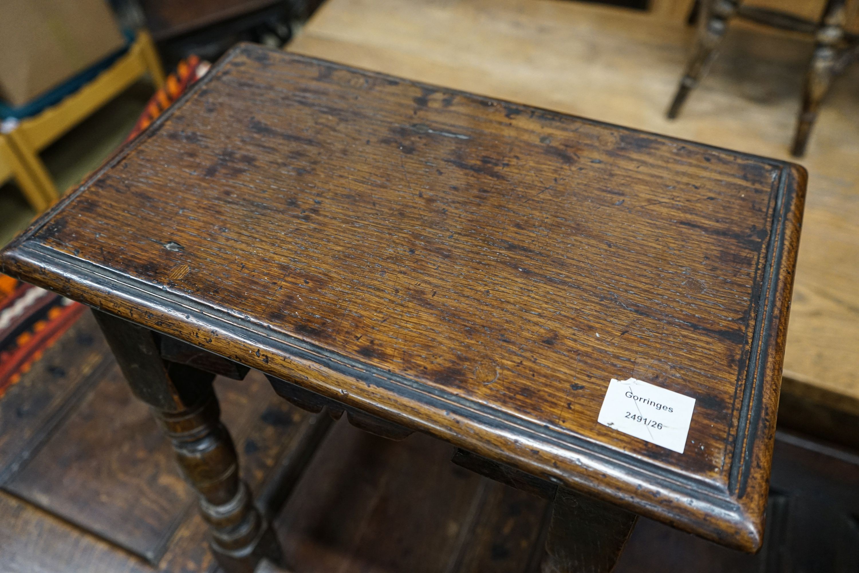 A 17th century style oak joint stool, with turned legs and carved apron, width 46cm, depth 27cm, height 56cm